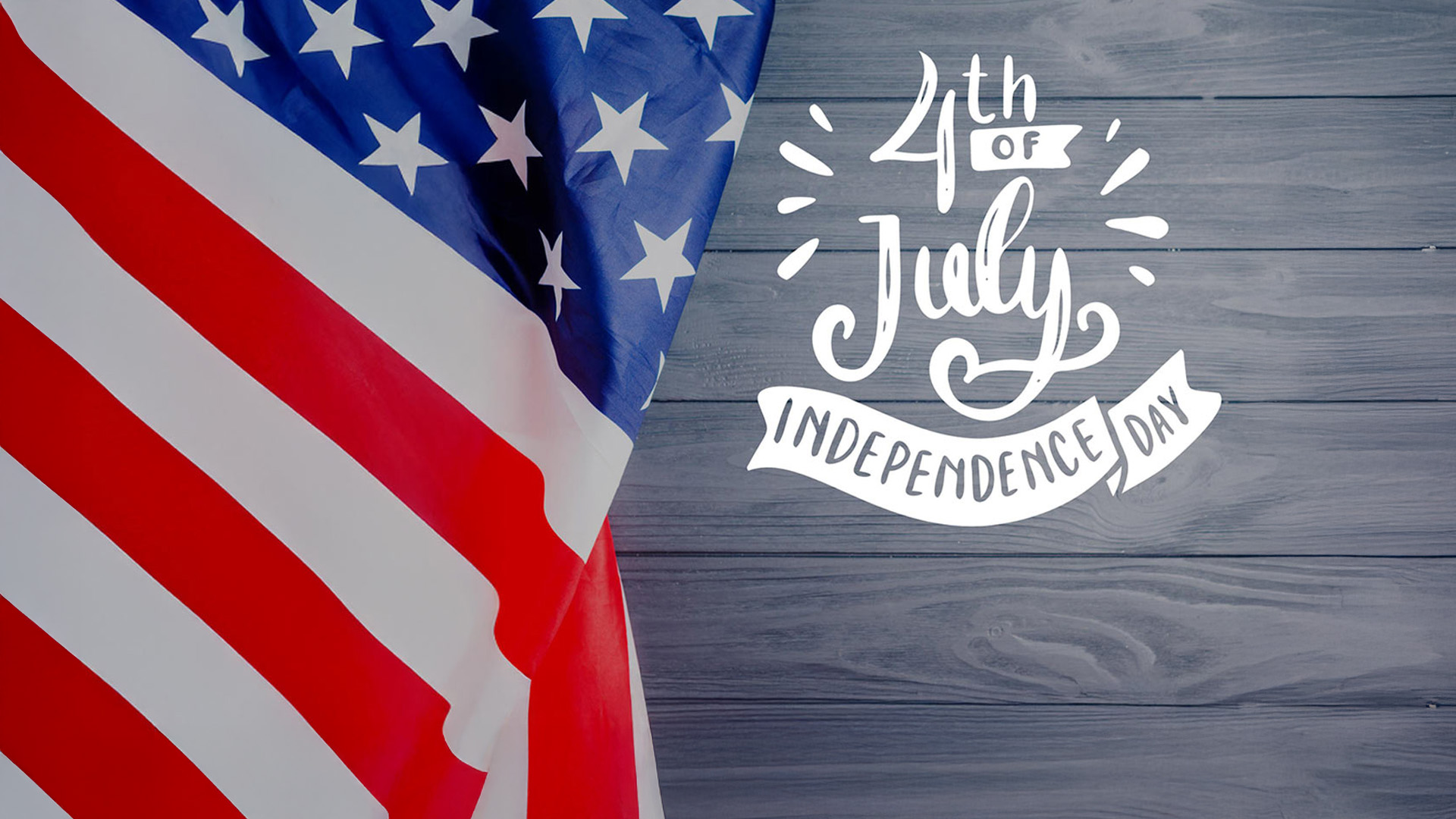 Close-up of the American flag with "4th of July Independence Day" text on a wooden background, symbolizing America's Independence Day.